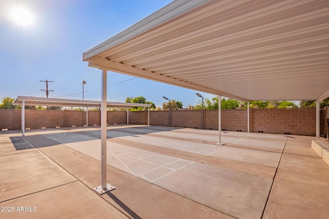 view of patio featuring fence and shuffleboard