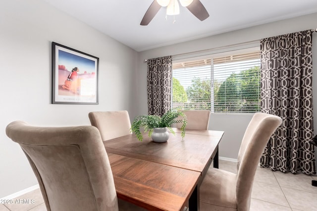 dining room featuring ceiling fan, baseboards, and light tile patterned flooring