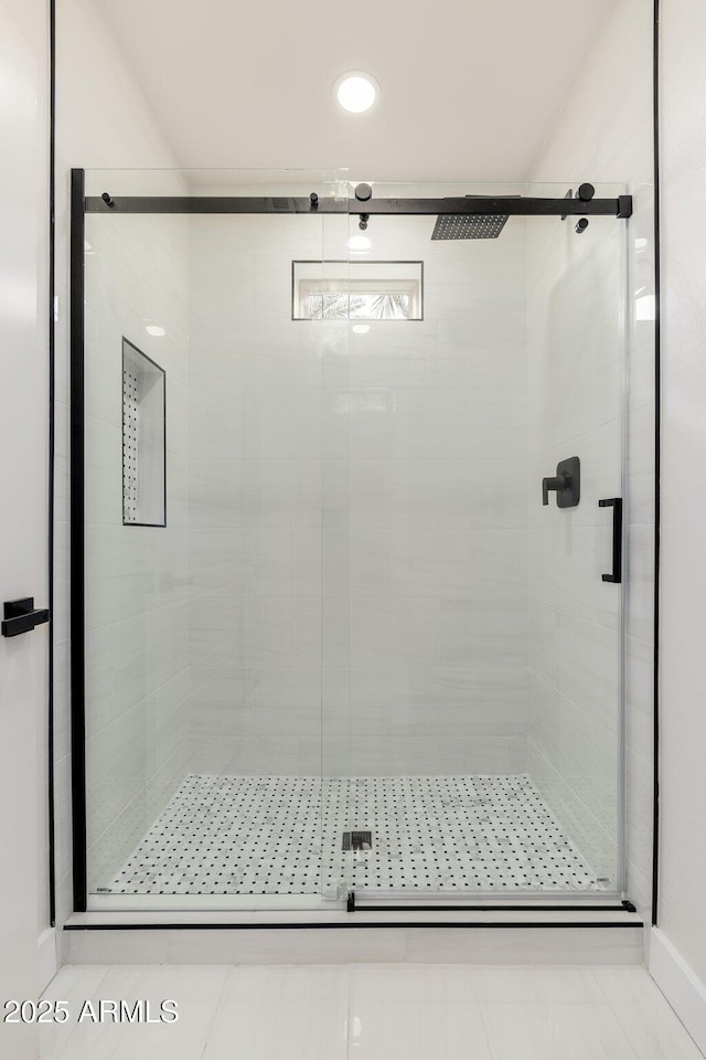 bathroom with tile patterned flooring and walk in shower