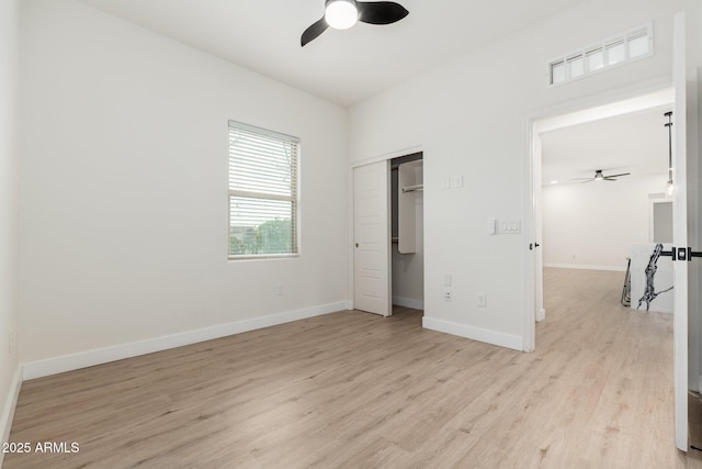 unfurnished bedroom featuring ceiling fan, a closet, and light hardwood / wood-style flooring