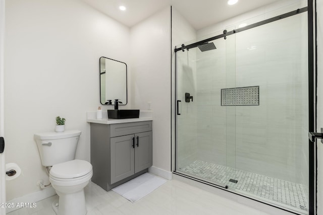 bathroom with vanity, an enclosed shower, and toilet