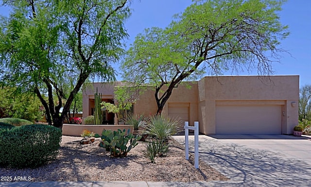 32516 N 68th Pl, Scottsdale, AZ 85266 - pueblo revival-style home featuring an attached garage, driveway, and stucco siding