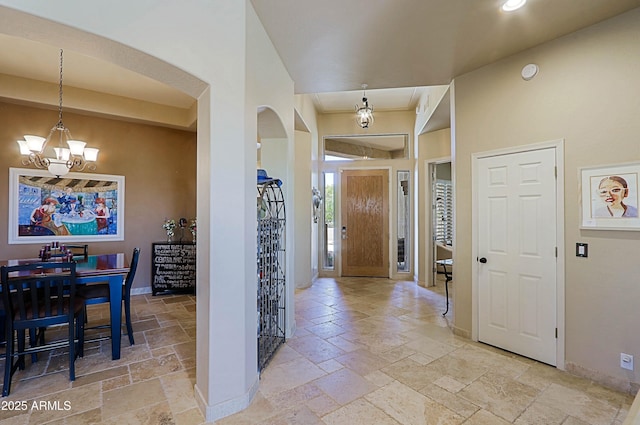 32516 N 68th Pl, Scottsdale, AZ 85266 - foyer featuring stone tile floors, arched walkways, a chandelier, baseboards, and recessed lighting