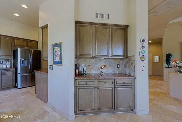 32516 N 68th Pl, Scottsdale, AZ 85266 - kitchen featuring stainless steel fridge, decorative backsplash, stone tile flooring, a towering ceiling, and recessed lighting