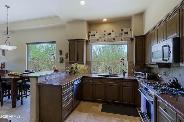 32516 N 68th Pl, Scottsdale, AZ 85266 - kitchen featuring appliances with stainless steel finishes, a sink, a peninsula, dark countertops, and recessed lighting
