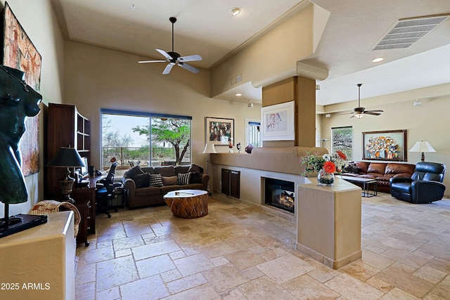 32516 N 68th Pl, Scottsdale, AZ 85266 - living room featuring ceiling fan, stone tile floors, plenty of natural light, a high ceiling, and recessed lighting