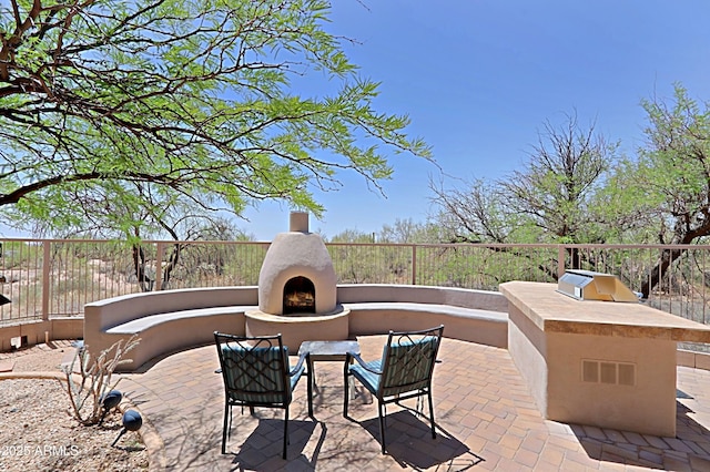 32516 N 68th Pl, Scottsdale, AZ 85266 - view of patio featuring a warm lit fireplace and area for grilling