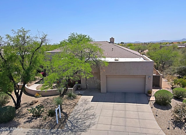 32516 N 68th Pl, Scottsdale, AZ 85266 - view of front of house featuring driveway, a garage, a chimney, stucco siding, and a tiled roof