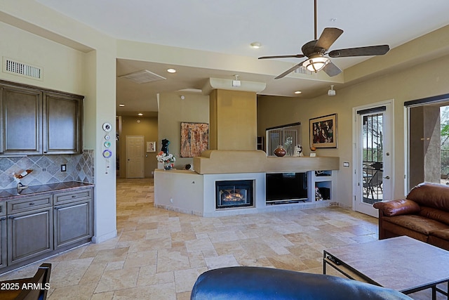 32516 N 68th Pl, Scottsdale, AZ 85266 - living area featuring stone tile flooring, ceiling fan, recessed lighting, and a fireplace