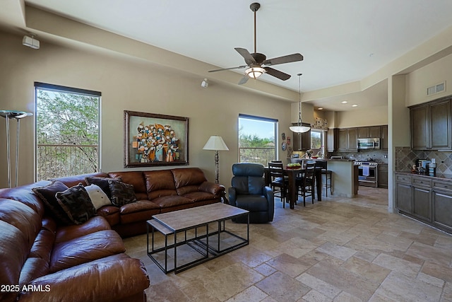 32516 N 68th Pl, Scottsdale, AZ 85266 - living area featuring a ceiling fan, stone tile floors, and recessed lighting