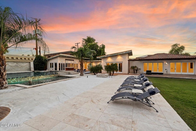 exterior space with a patio, an outbuilding, and a yard