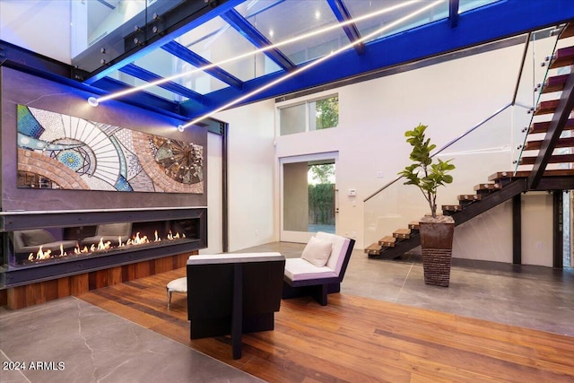 interior space featuring wood-type flooring and high vaulted ceiling