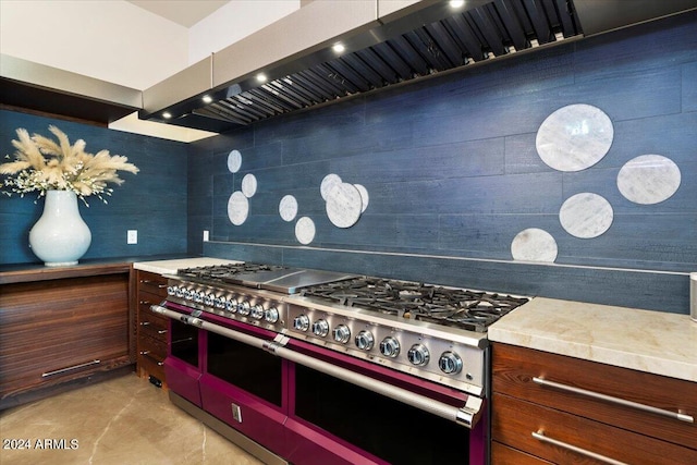 kitchen featuring range hood and range with two ovens