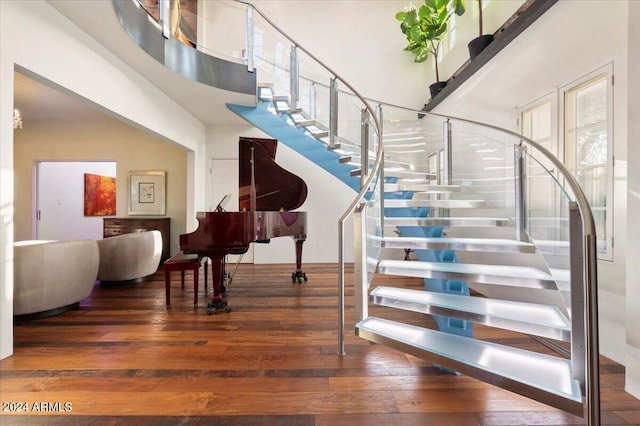 staircase with hardwood / wood-style floors