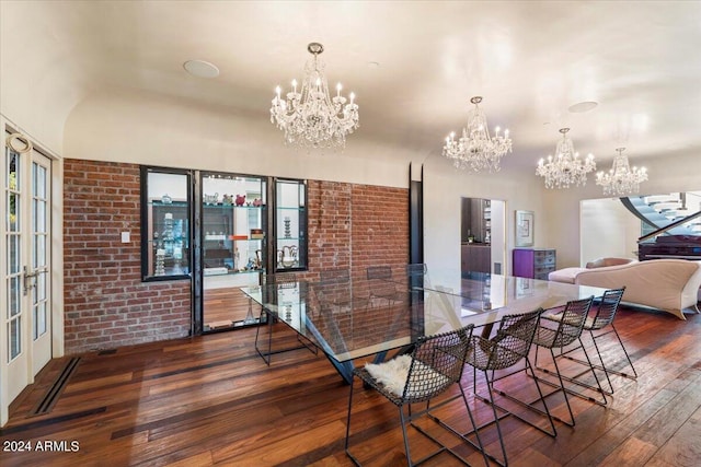 dining room with dark hardwood / wood-style floors and brick wall