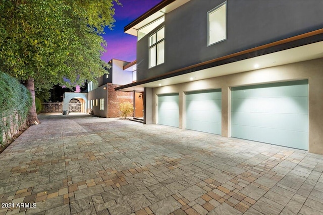 property exterior at dusk featuring a garage