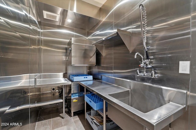 kitchen with stainless steel counters and tile patterned flooring