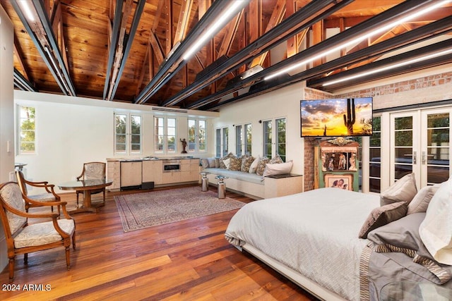 bedroom with multiple windows, wood ceiling, hardwood / wood-style floors, and french doors