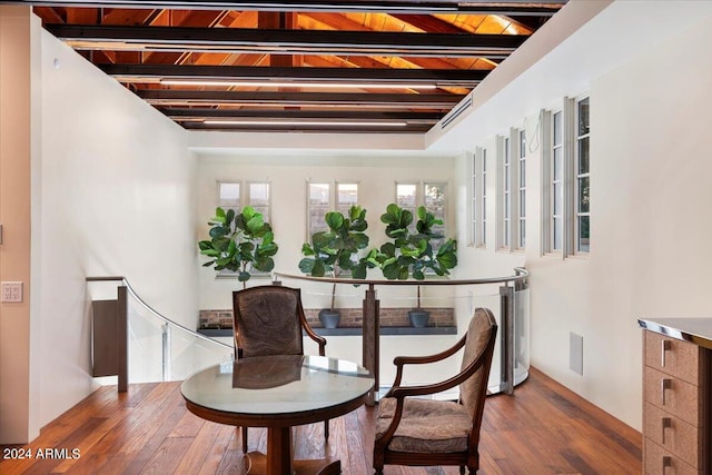 dining area featuring wood ceiling, wood-type flooring, and beamed ceiling