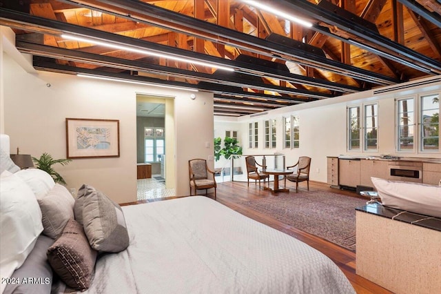 bedroom with wood ceiling, wood-type flooring, and beam ceiling