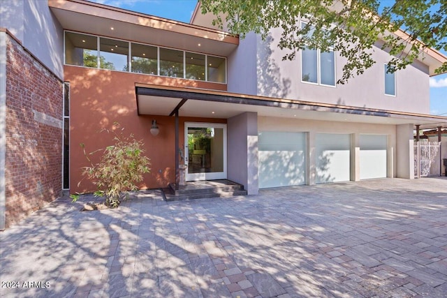 back of house featuring a garage