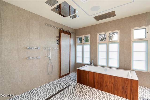 bathroom with shower with separate bathtub and tile patterned floors