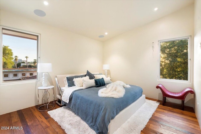 bedroom with vaulted ceiling and dark hardwood / wood-style flooring