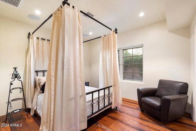 bedroom with dark hardwood / wood-style floors