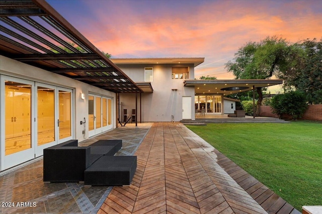 exterior space with french doors, an outdoor hangout area, a lawn, and a patio area