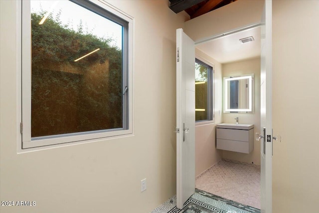 bathroom with vanity, tile patterned floors, and a wealth of natural light