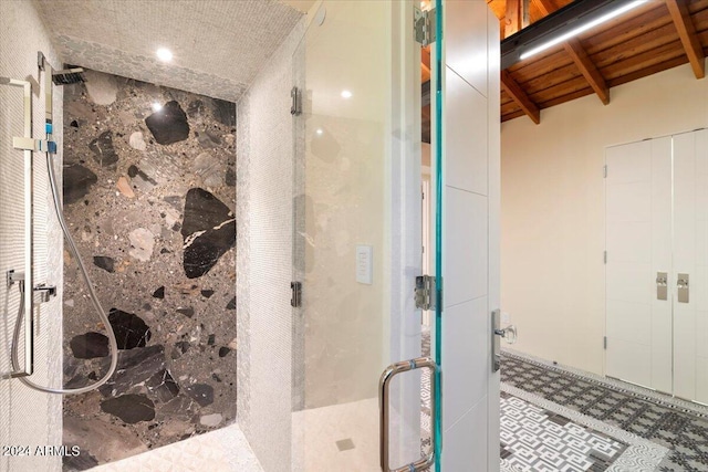 bathroom featuring vaulted ceiling with beams, wood ceiling, and a shower with door