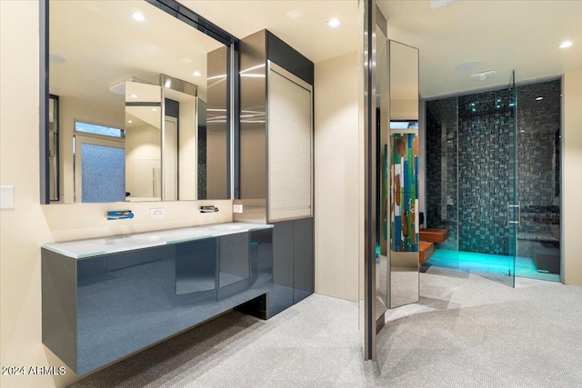 bathroom featuring vanity and a shower with door