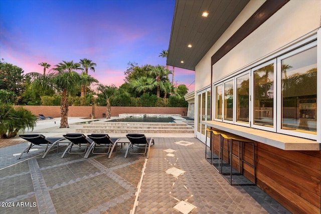 view of patio terrace at dusk