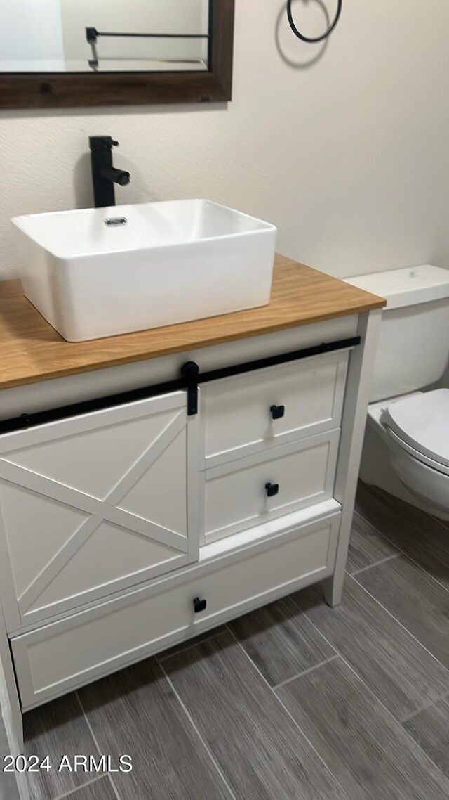 bathroom featuring vanity and toilet