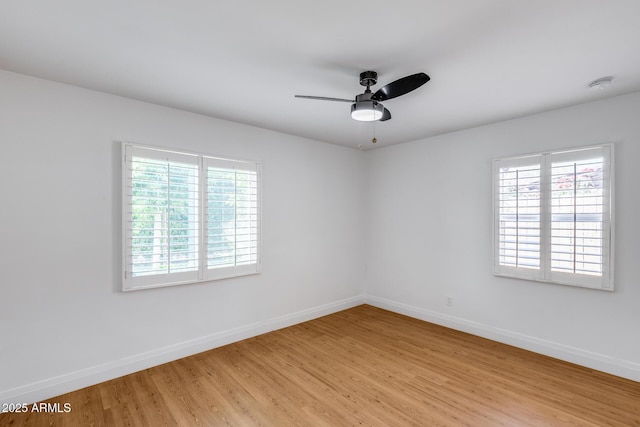 2336 E Flower St, Phoenix, AZ 85016 - empty room with plenty of natural light, light wood finished floors, and baseboards