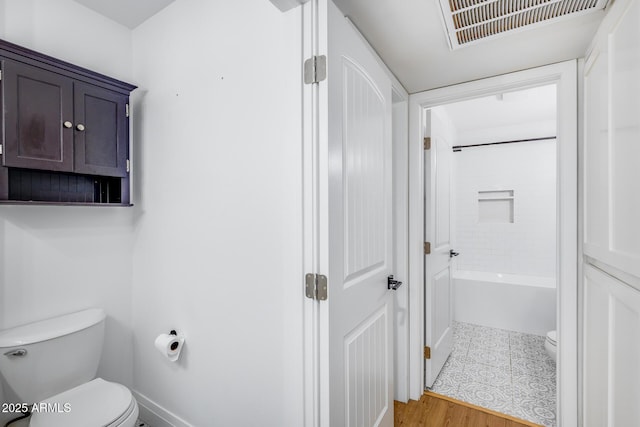 2336 E Flower St, Phoenix, AZ 85016 - bathroom with toilet, baseboards, and wood finished floors