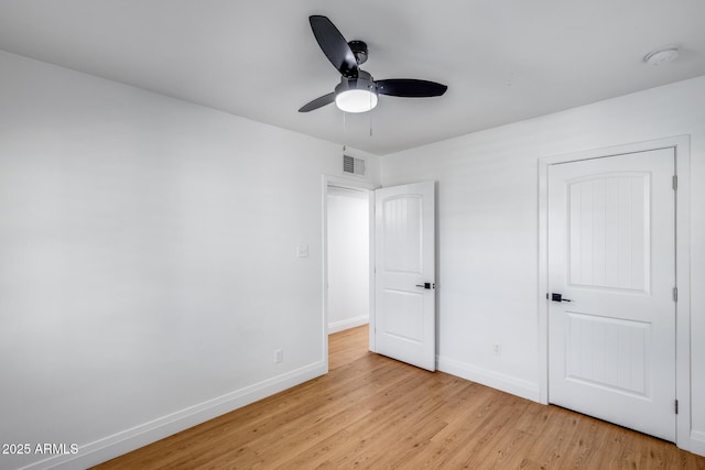 2336 E Flower St, Phoenix, AZ 85016 - unfurnished bedroom with light wood-type flooring, baseboards, and a ceiling fan