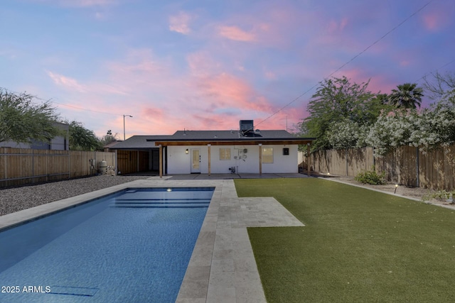 2336 E Flower St, Phoenix, AZ 85016 - back of property at dusk with a patio area