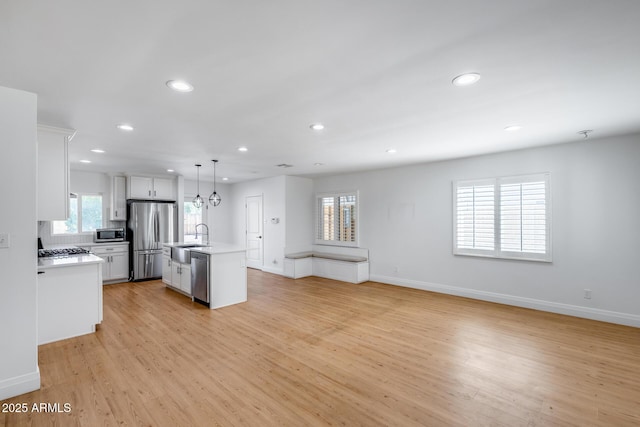 2336 E Flower St, Phoenix, AZ 85016 - kitchen with stainless steel appliances, a sink, recessed lighting, light countertops, and light wood finished floors
