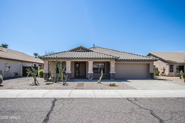 3127 W Folgers Rd, Phoenix, AZ 85027 - view of front of house featuring covered porch, a garage, concrete driveway, a tiled roof, and stucco siding
