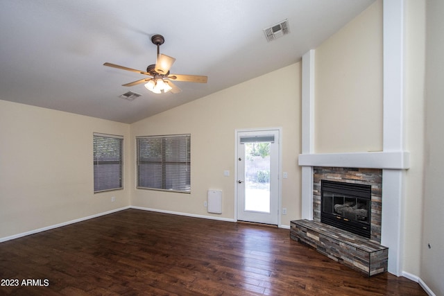 unfurnished living room featuring vaulted ceiling, a fireplace, ceiling fan, and dark hardwood / wood-style flooring