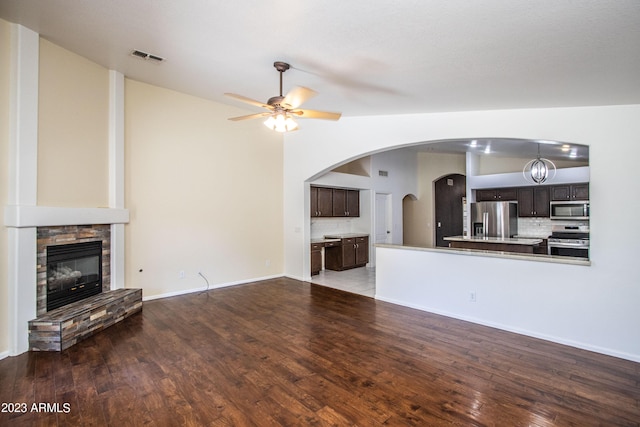 living room featuring ceiling fan, hardwood / wood-style floors, and a fireplace