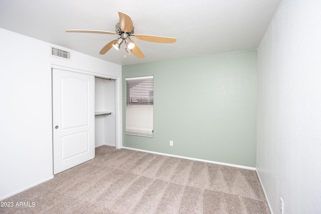 unfurnished bedroom featuring carpet flooring, a closet, and ceiling fan