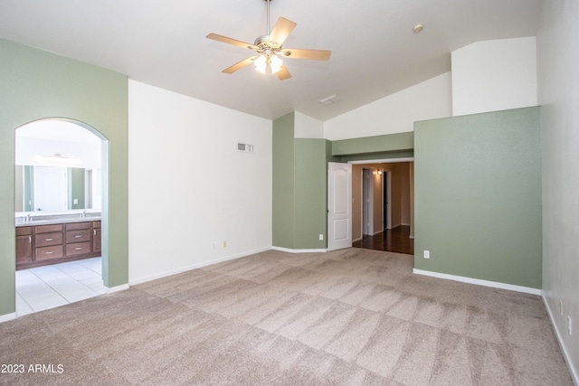 spare room with sink, high vaulted ceiling, light carpet, and ceiling fan