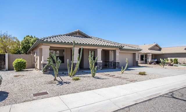 3127 W Folgers Rd, Phoenix, AZ 85027 - view of front of home with a tile roof, a porch, an attached garage, fence, and concrete driveway