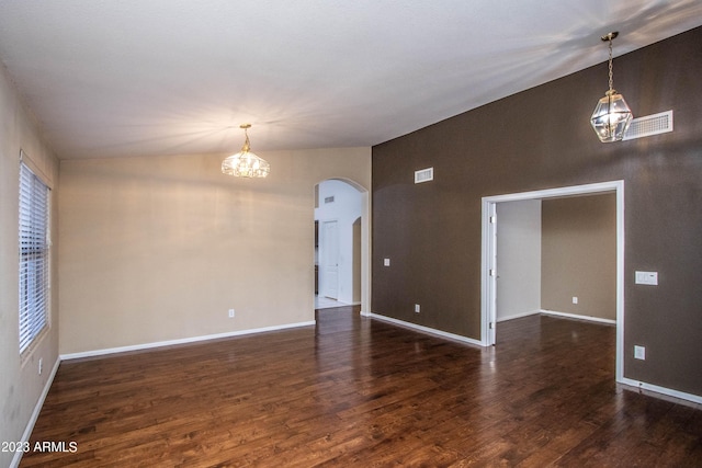 unfurnished room featuring a chandelier, lofted ceiling, and dark hardwood / wood-style floors