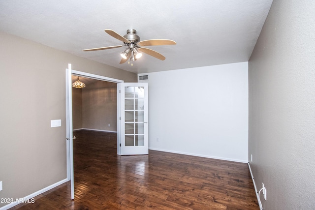 spare room featuring french doors, ceiling fan, and dark hardwood / wood-style floors