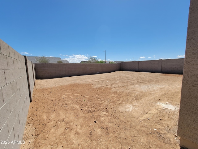 view of yard with a fenced backyard