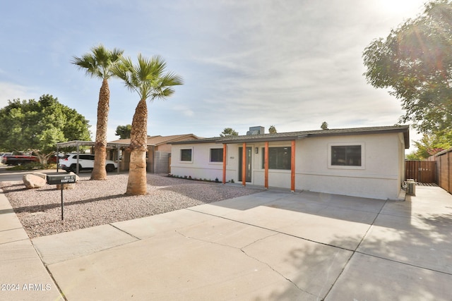 ranch-style house with a patio area and a carport