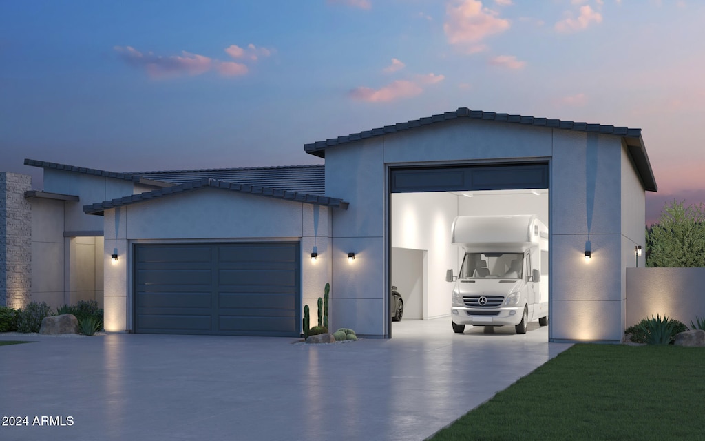 view of front of house featuring a garage and a lawn